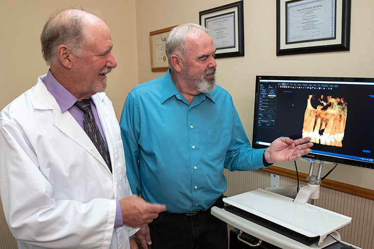 A patient viewing 3D imaging of his teeth