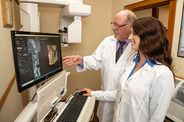 Dr. Herndon and Dr. Luscri looking at high-tech 3D implant planning software