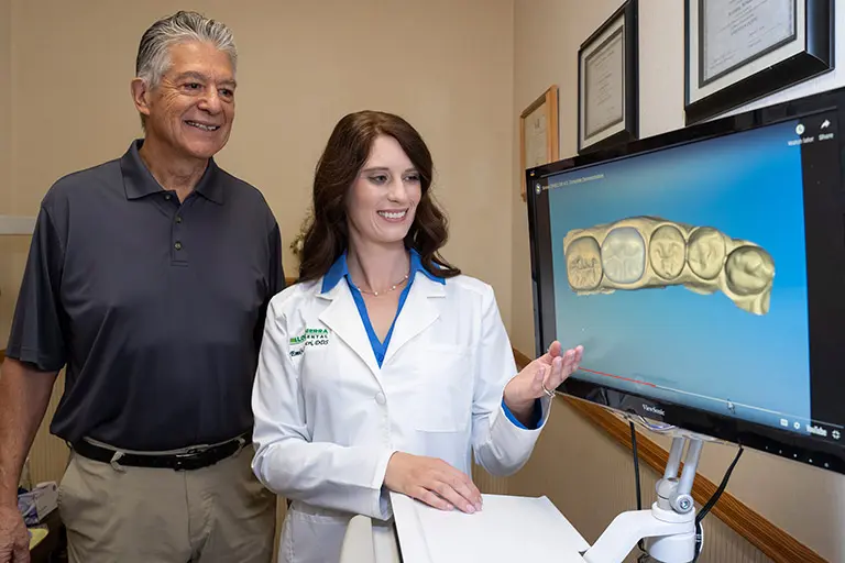 Dr. Luscri showing a patient same-day crowns with CEREC.