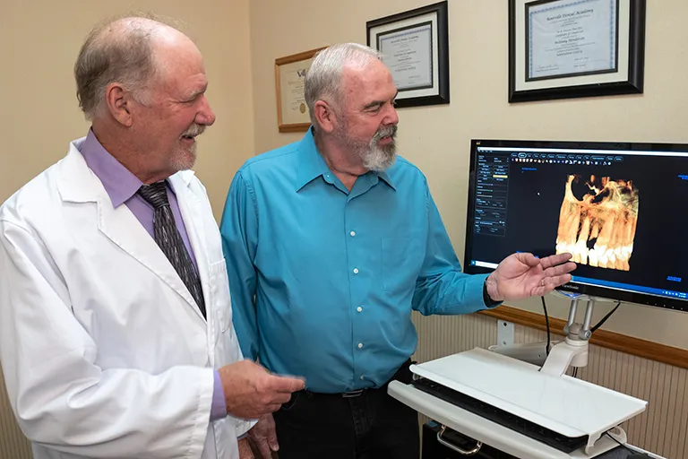 Dr. Herndon showing a patient a 3D implant placement.