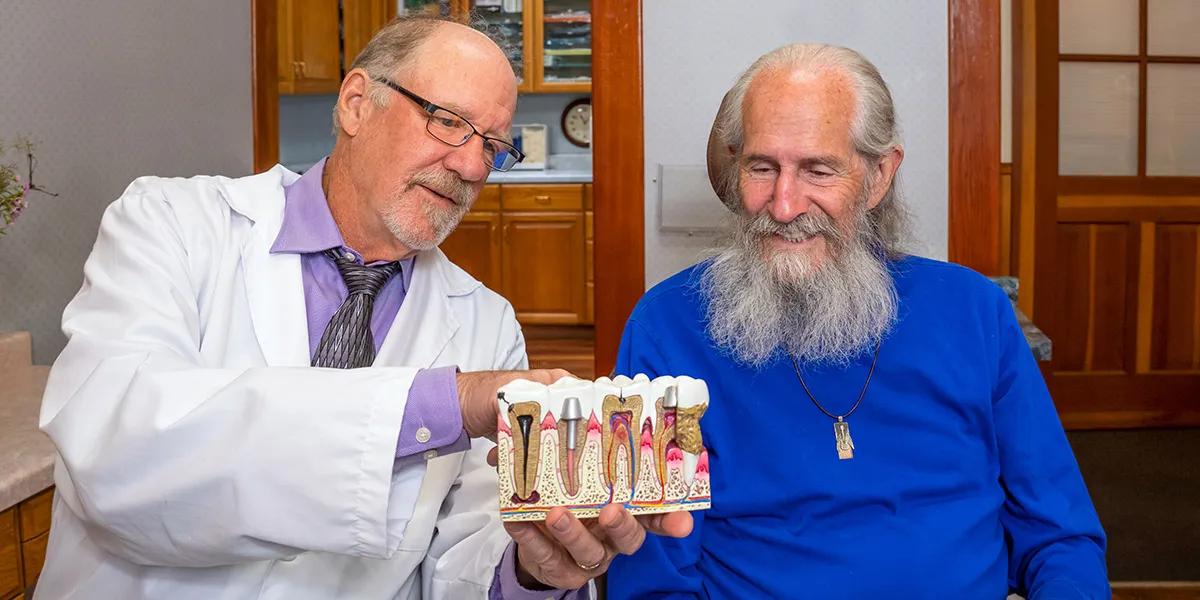 Dr. Herndon explaining dental implants to a patient.