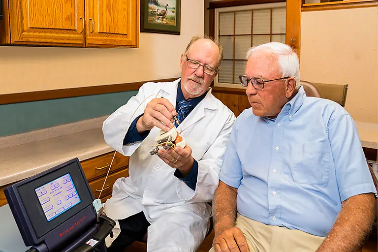 Dr. Herndon in a consultation with a patient for gum disease treatment.