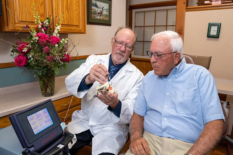 Dr. Herndon with a patient in a consultation for laser gum disease treatment.