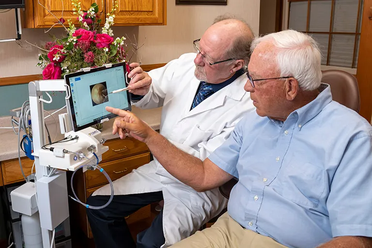 Dr. Herndon showing a patient a Perioscope on a computer monitor.