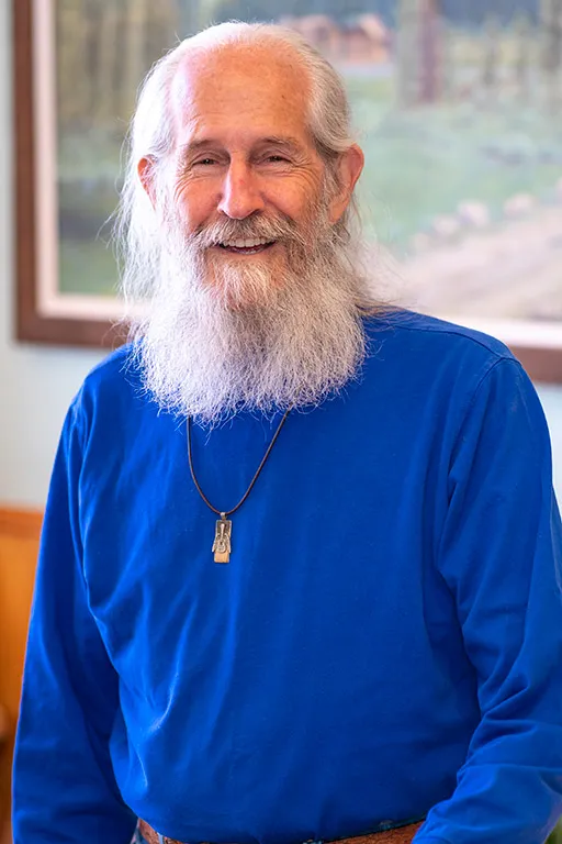 Image of a patient who received dental treatment smiling for a testimonial portrait.