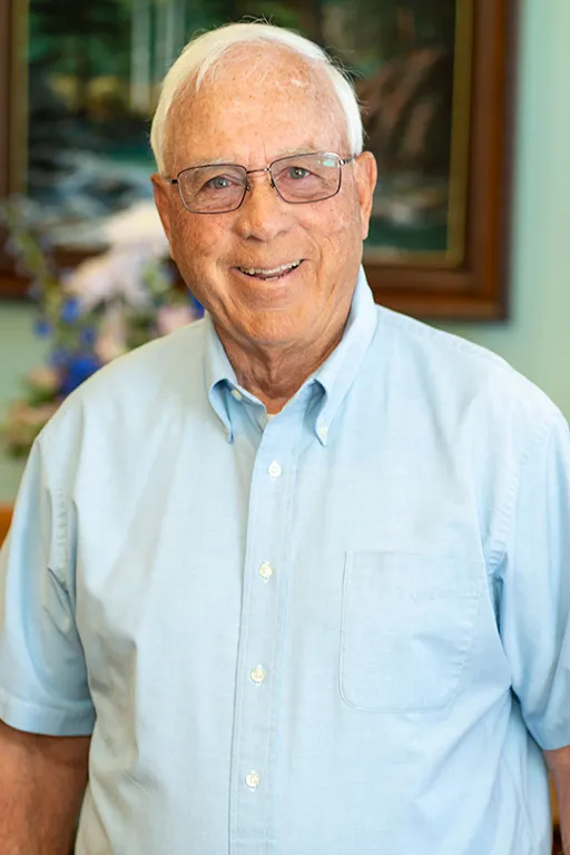 Image of a patient who received dental treatment smiling for a testimonial portrait.