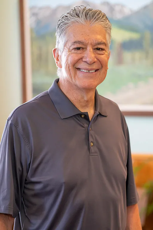 Image of a patient who received dental treatment smiling for a testimonial portrait.