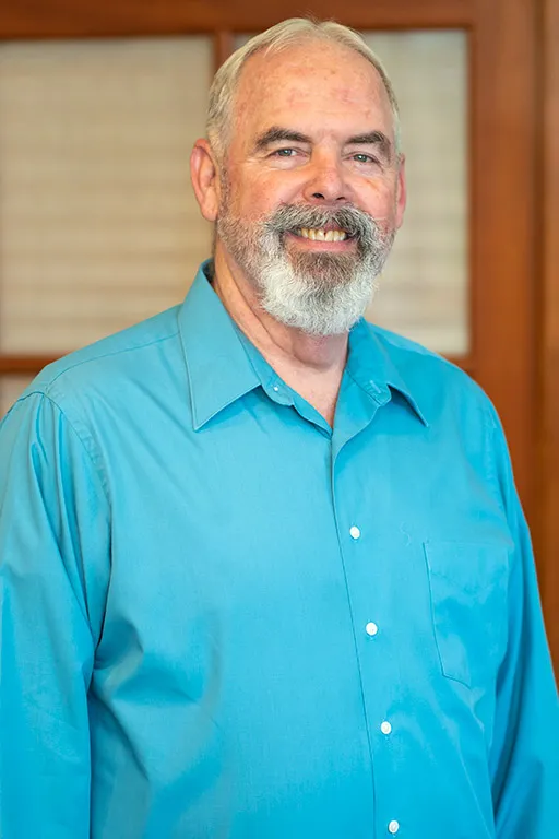 Image of a patient who received dental treatment smiling for a testimonial portrait.